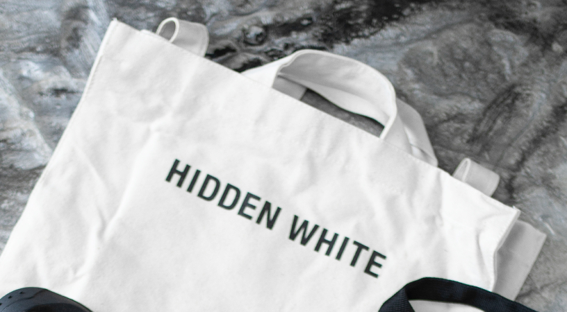 A picture of Hidden White tote bag with logo.