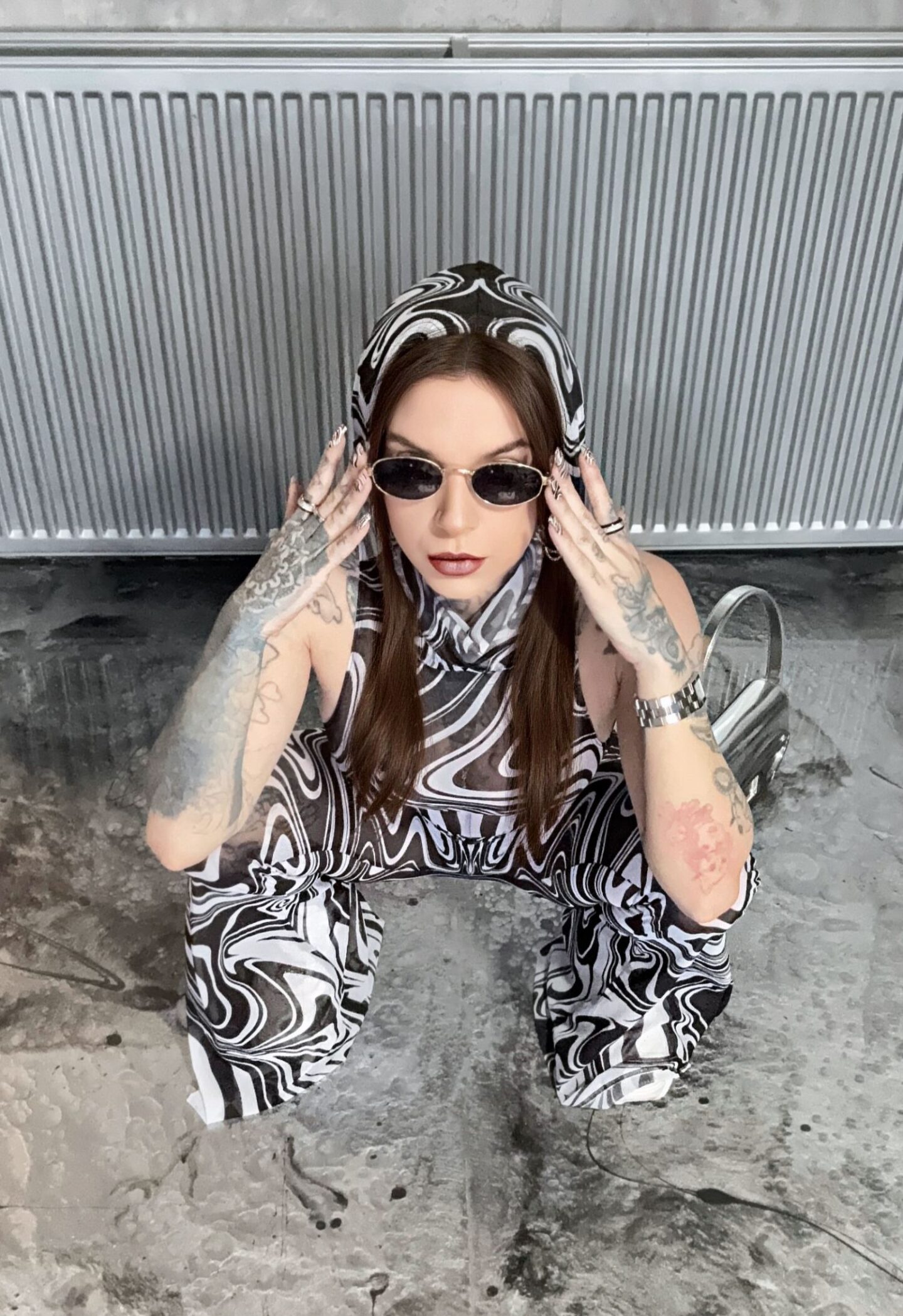 A creative picture of Eve Sara styling and wearing a Devil Walking outfit.