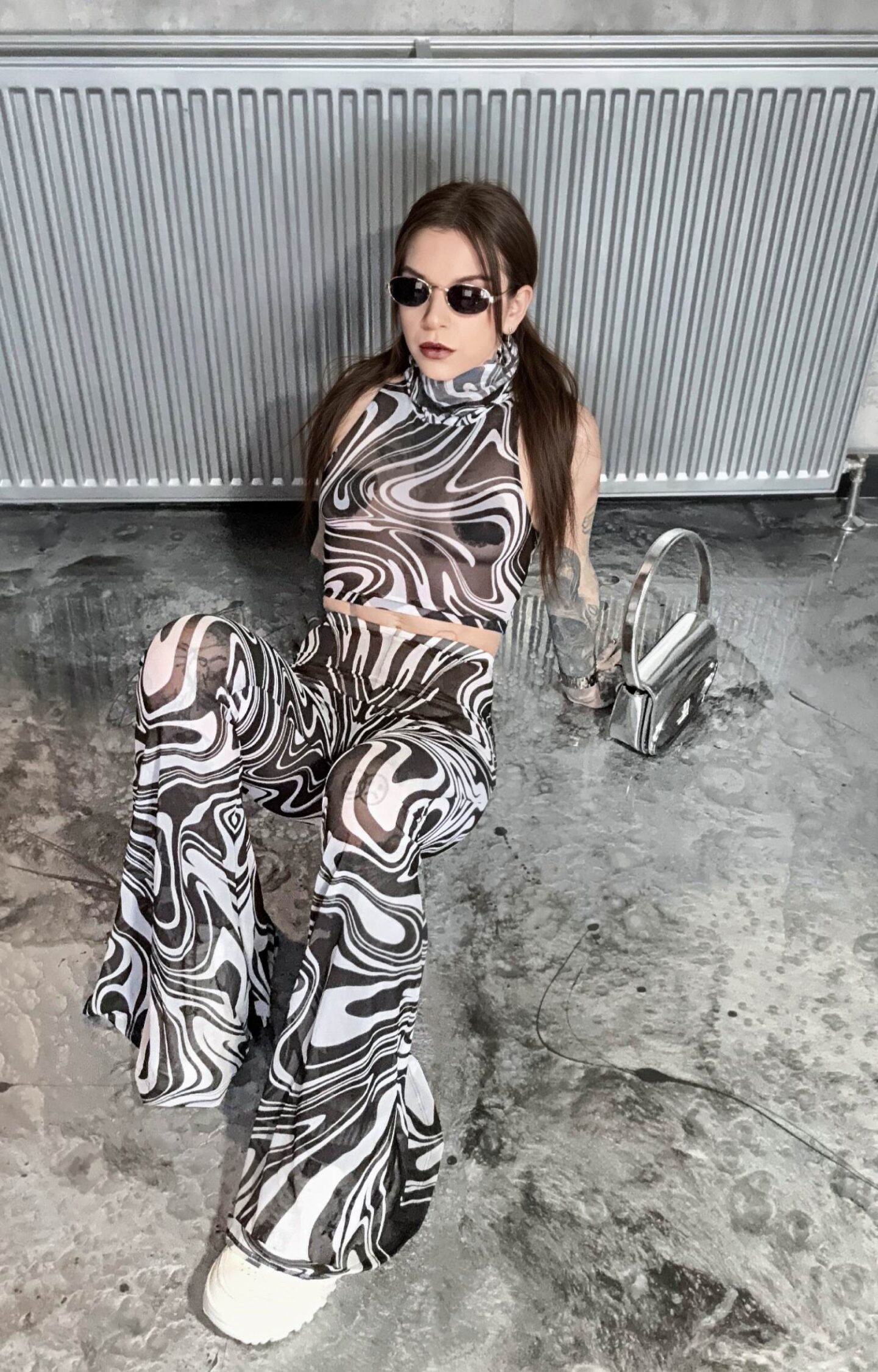 A picture of Eve Sara wearing the Dissonance Flared Pants Set from Devil Walking.