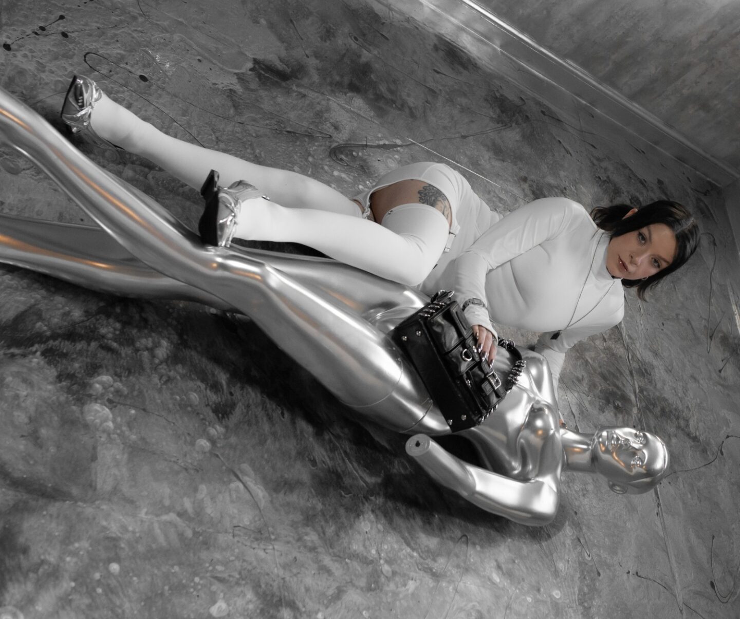 A picture of Eve Sara modelling the Talia 2 way Ring Bag and Astra Arch Sneaker Heels from Asyllum.