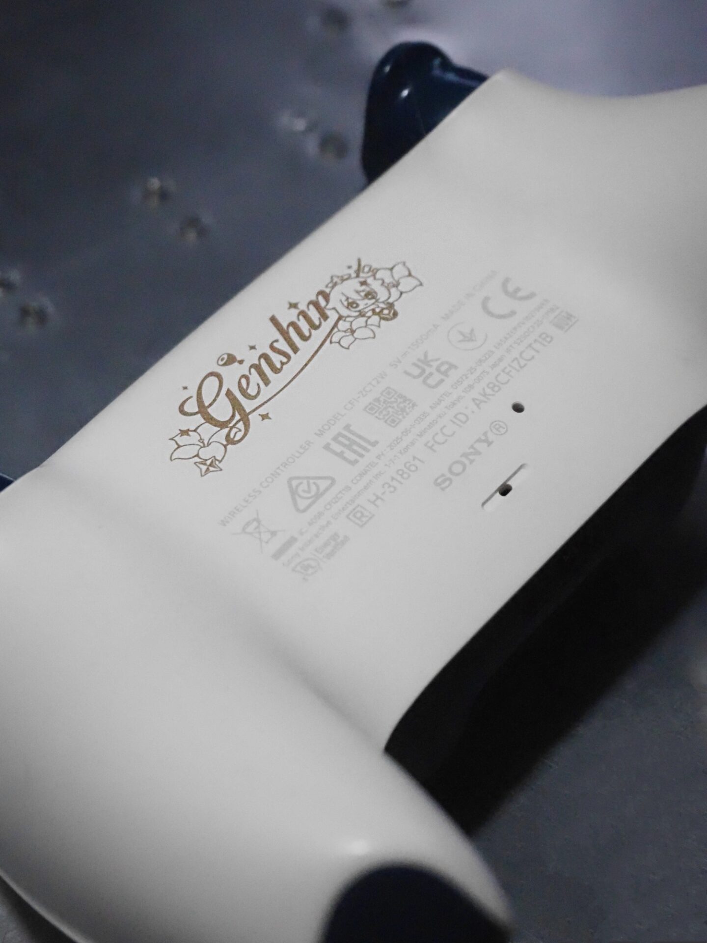 A close up picture of the back of the new Genshin Impact controller in detail.