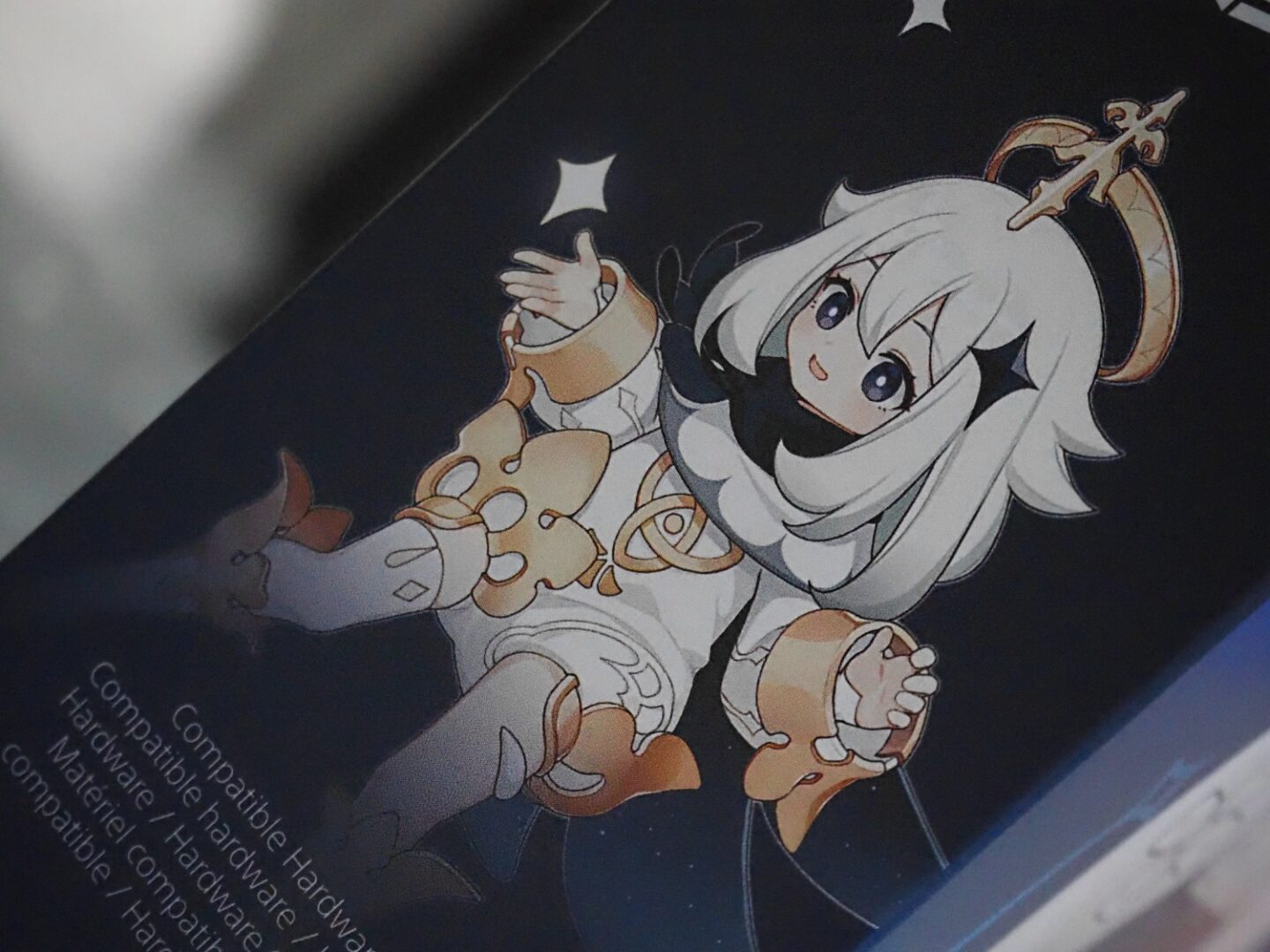 A close up picture of the Genshin Impact controller box with Pimon.